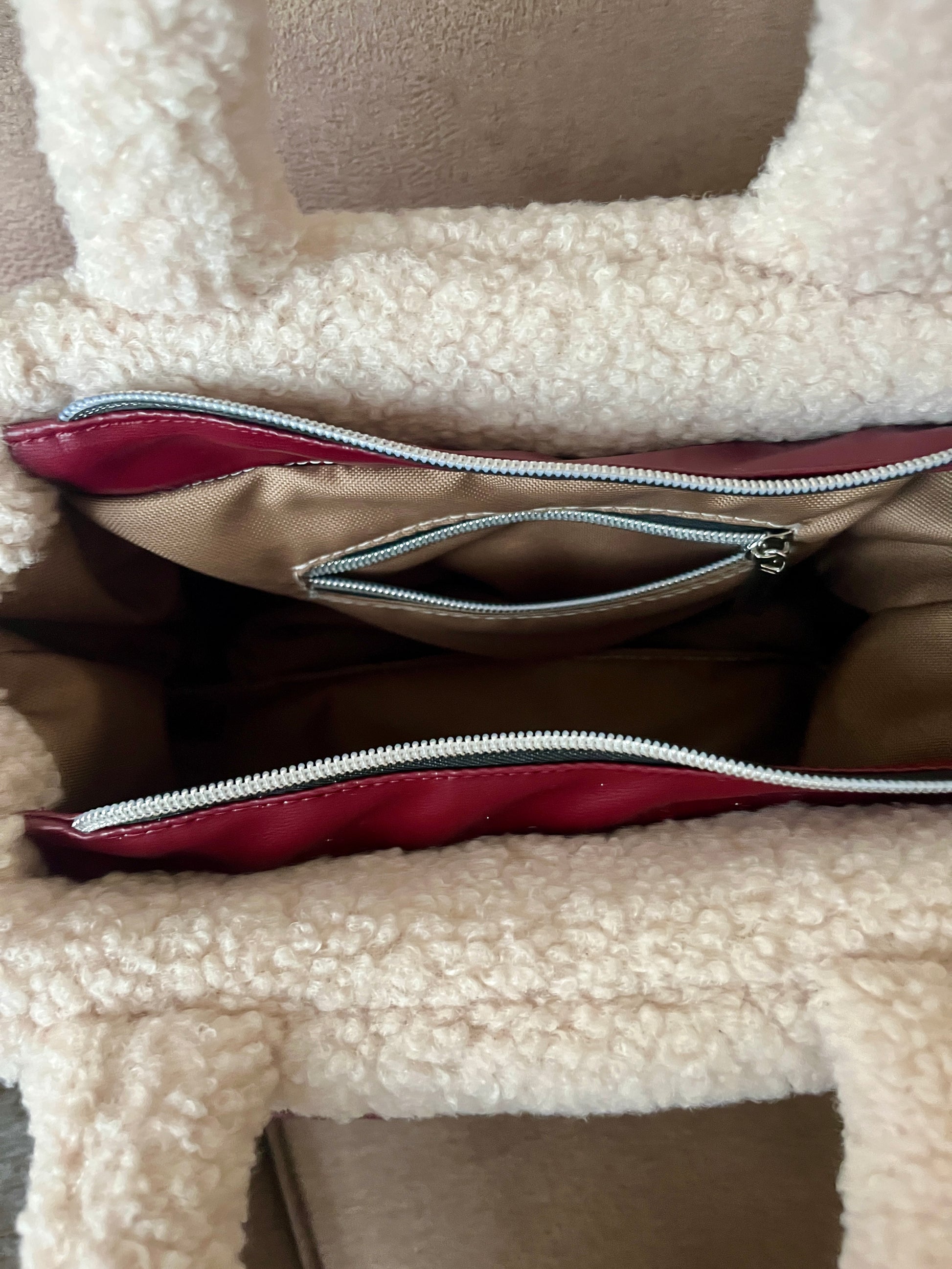 Zacht, stijlvol en met een luxe twist. Ivory & Wine is een handgemaakte teddy tas in een warme ivoortint, afgewerkt met een elegante bordeauxrode schouderband. 